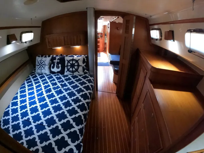 Slide: The Image of Cozy cabin interior of 1999 Island Packet 45 sailboat with nautical-themed bedding. - 18