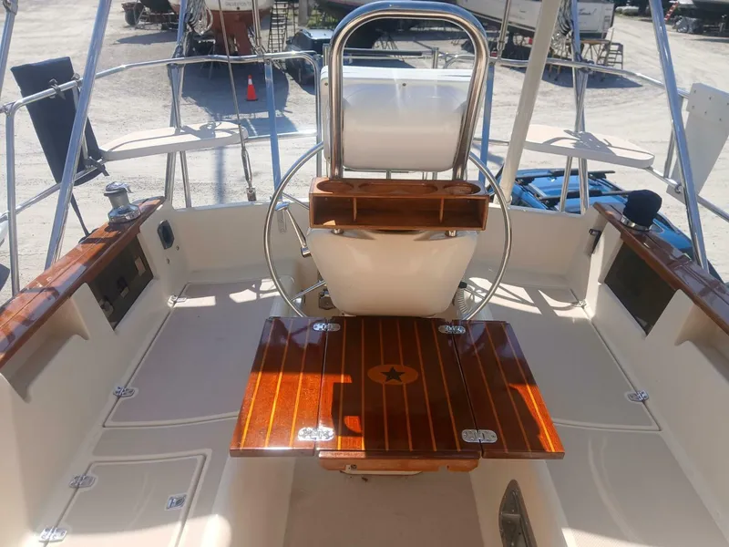 Slide: The Image of Cockpit of 1999 Island Packet 45 sailboat with wooden accents and steering wheel. - 2