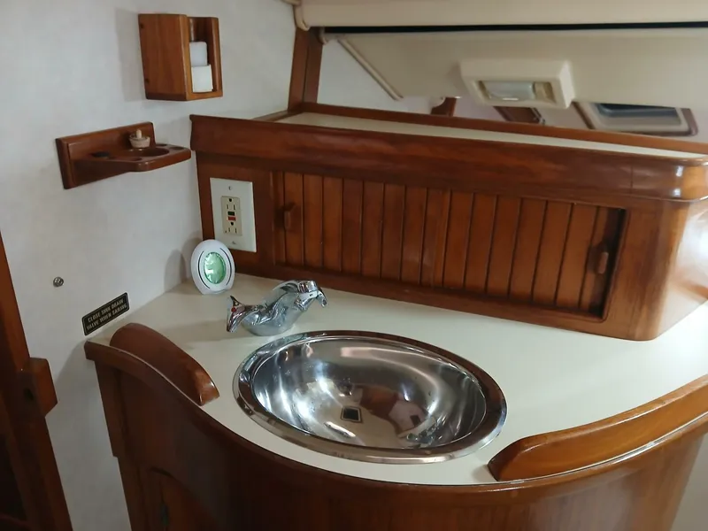 Slide: The Image of Interior of 1999 Island Packet 45 yacht with wooden cabinetry and stainless steel sink. - 24