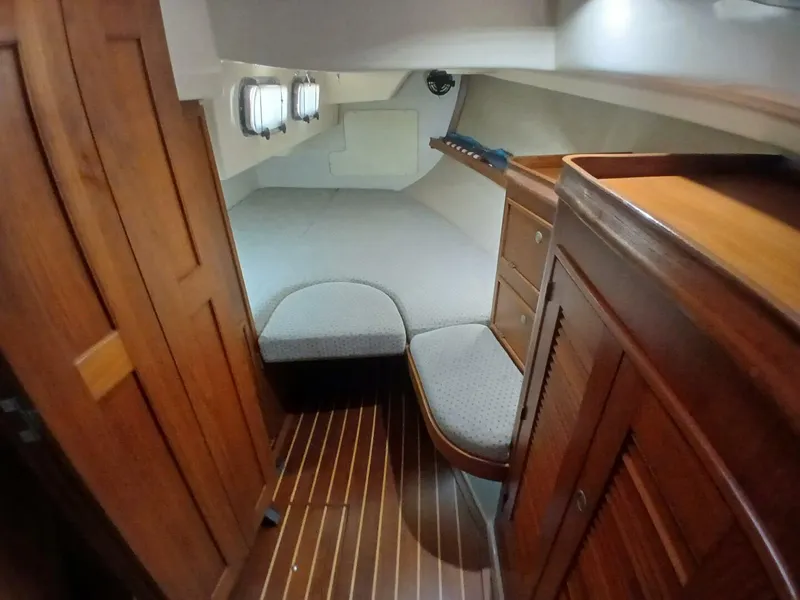 Slide: The Image of 1999 Island Packet 45 yacht interior cabin with wooden furnishings and cozy bed. - 27