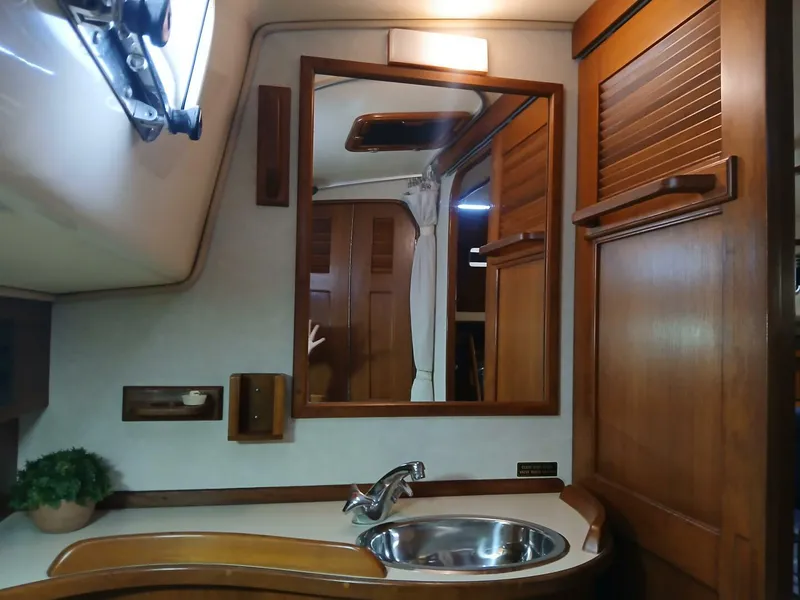 Slide: The Image of Interior of 1999 Island Packet 45 yacht with wooden cabinetry and sink. - 30