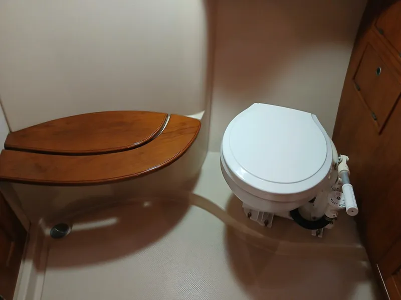 Slide: The Image of 1999 Island Packet 45 yacht bathroom with wooden seat and marine toilet. - 32