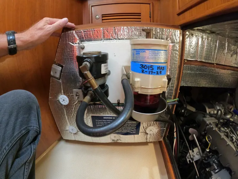 Slide: The Image of Engine compartment of a 1999 Island Packet 45 sailboat, featuring fuel filter and insulation. - 36