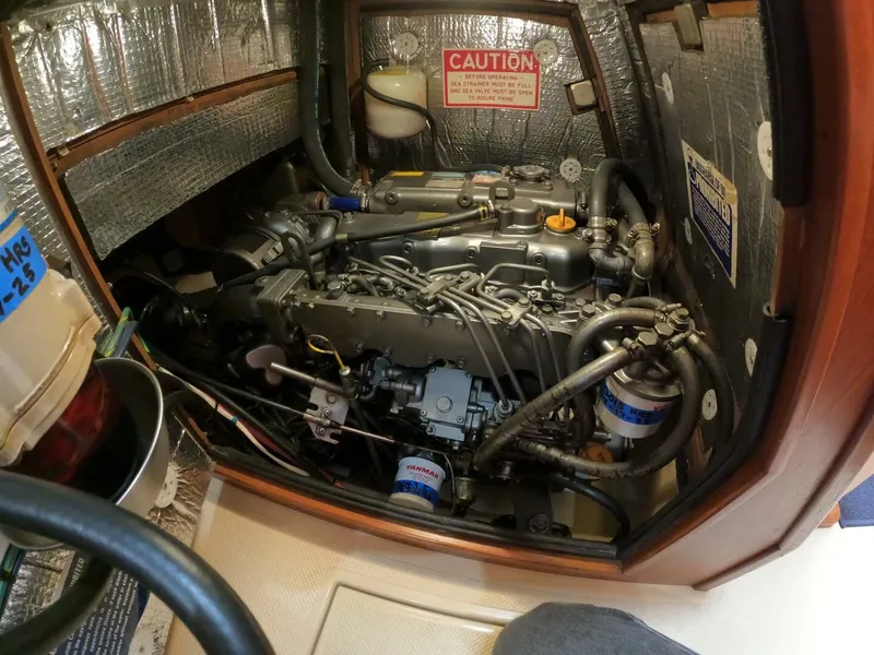 Slide: The Image of Engine compartment of a 1999 Island Packet 45 sailboat, showcasing detailed mechanical components. - 37