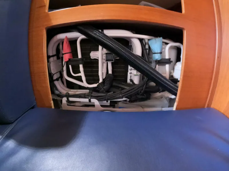 Slide: The Image of 1999 Island Packet 45 interior showing plumbing and wiring behind wooden panel. - 39