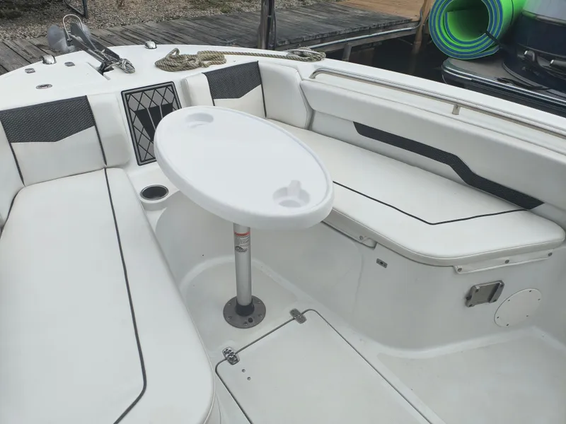 Slide: The Image of 2020 Wellcraft 222 Fisherman boat interior with seating and table setup. - 10