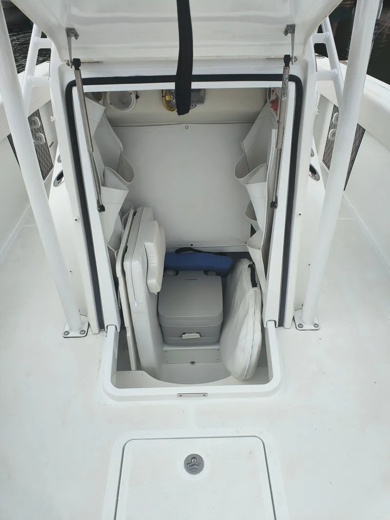 Slide: The Image of 2020 Wellcraft 222 Fisherman boat interior storage compartment with seating and equipment. - 12