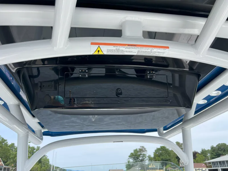 Slide: The Image of 2020 Wellcraft 222 Fisherman boat console with storage compartment and warning label. - 16