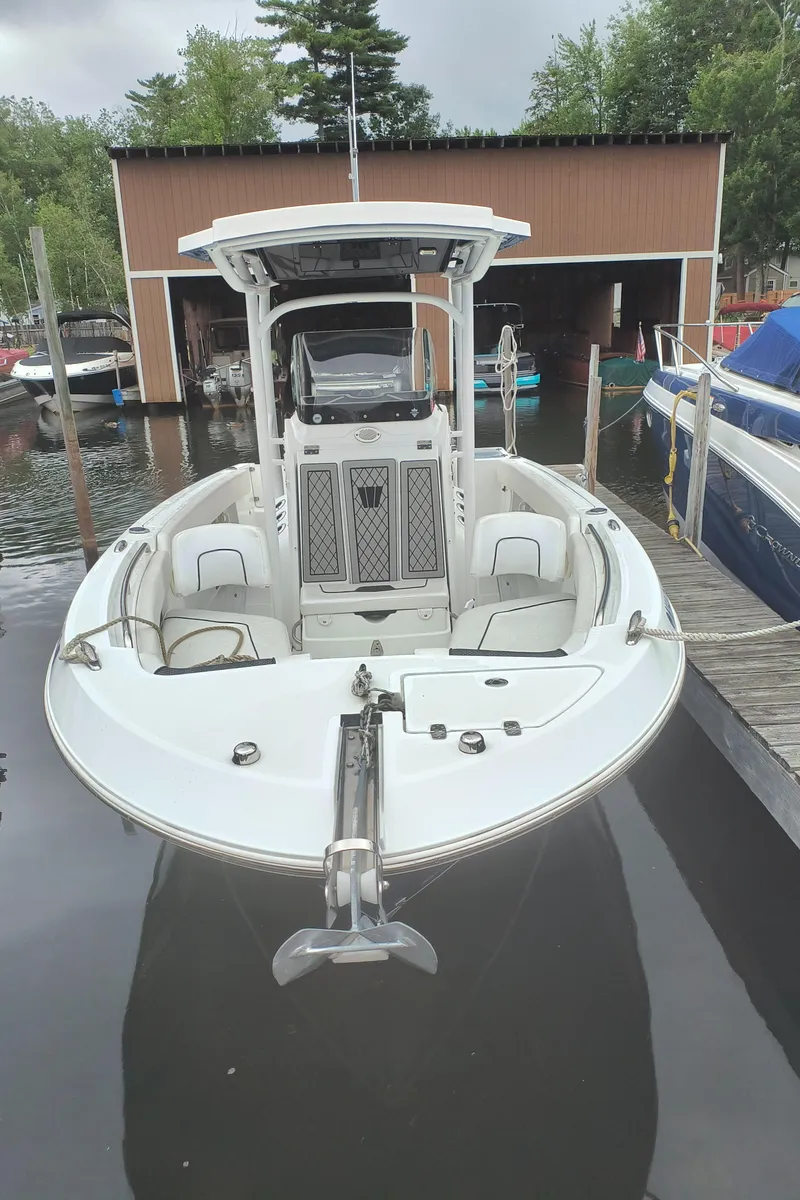 Slide: The Image of 2020 Wellcraft 222 Fisherman boat docked at marina, front view. - 2