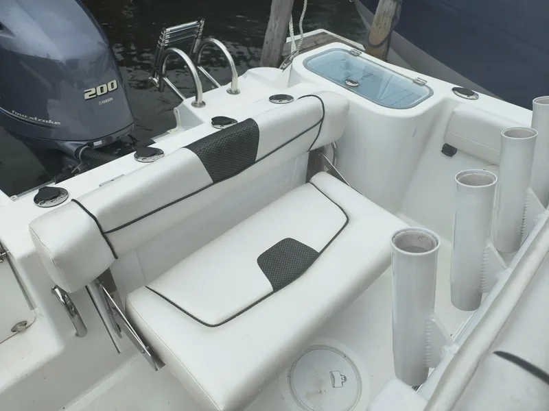 Slide: The Image of 2020 Wellcraft 222 Fisherman boat interior with Yamaha 200 engine, rod holders, and seating. - 20