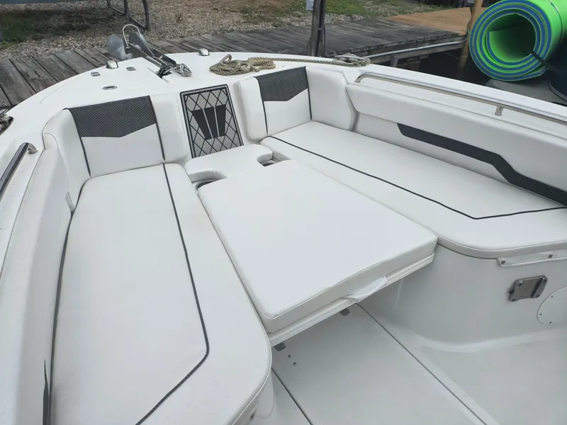 Slide: The Image of 2020 Wellcraft 222 Fisherman boat interior with white cushioned seating and storage compartments. - 5
