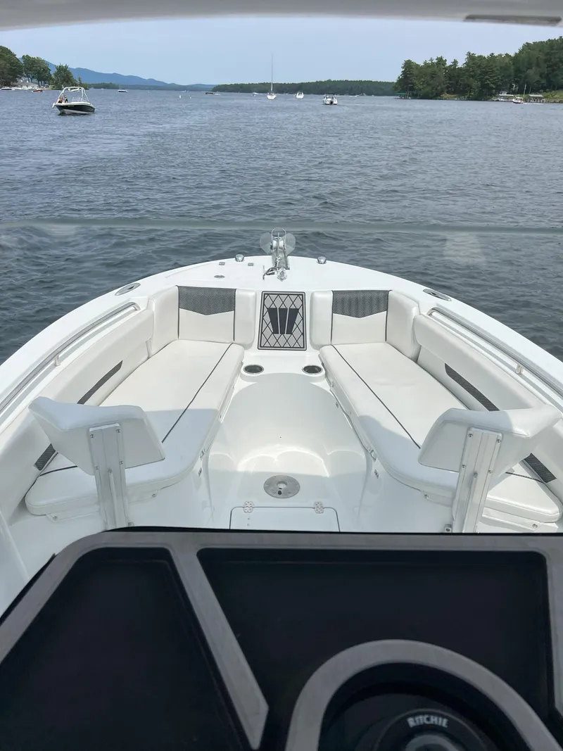 Slide: The Image of 2020 Wellcraft 222 Fisherman boat on a calm lake with scenic background. - 6