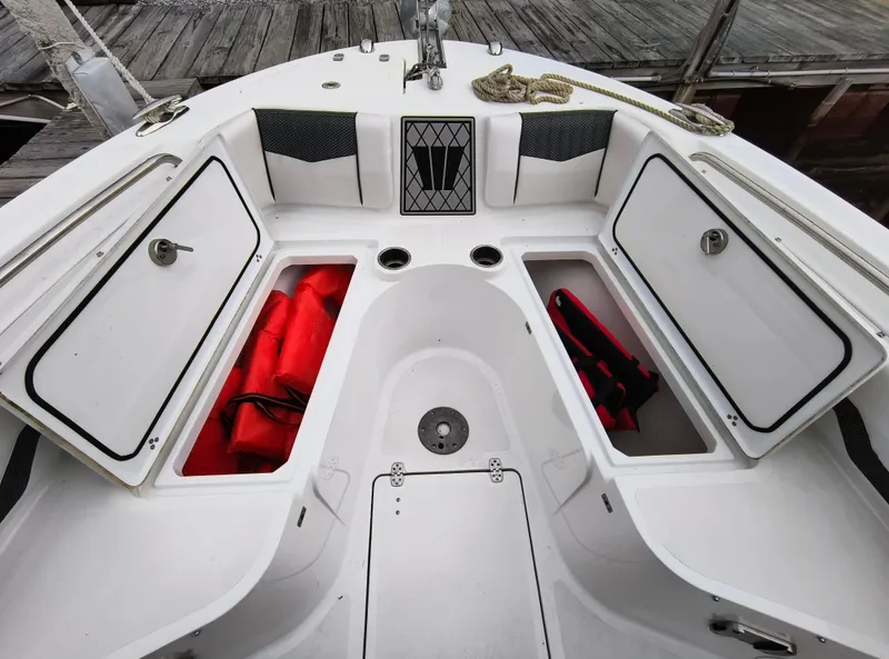 Slide: The Image of 2020 Wellcraft 222 Fisherman boat storage compartments with life jackets and safety equipment. - 9