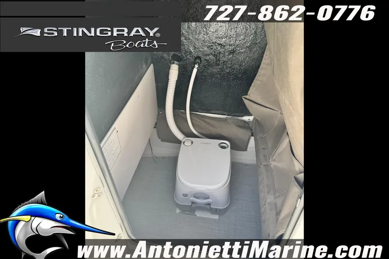 Slide: The Image of 2026 Stingray 206 CC boat interior with portable toilet, featuring marine equipment. - 16