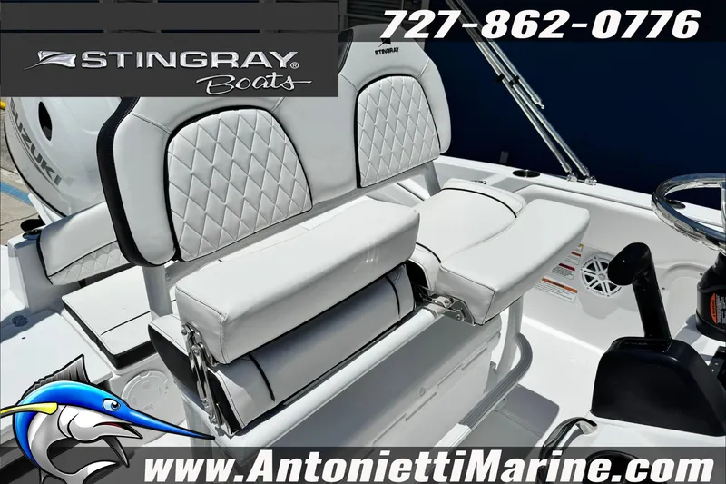 Slide: The Image of Stingray 206 CC 2026 boat interior with white seating, steering wheel, and logo. - 29
