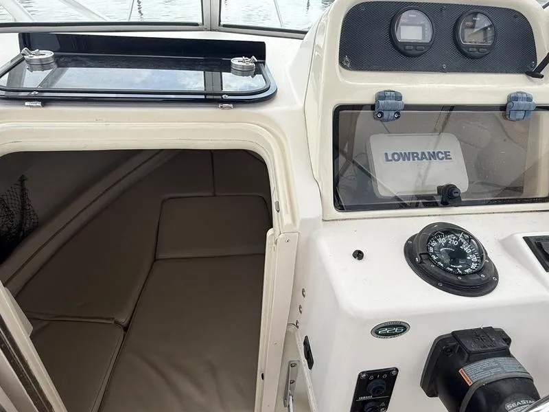 Slide: The Image of 2003 Grady-White 226 Sea Farer boat interior with navigation equipment and cabin entrance. - 10