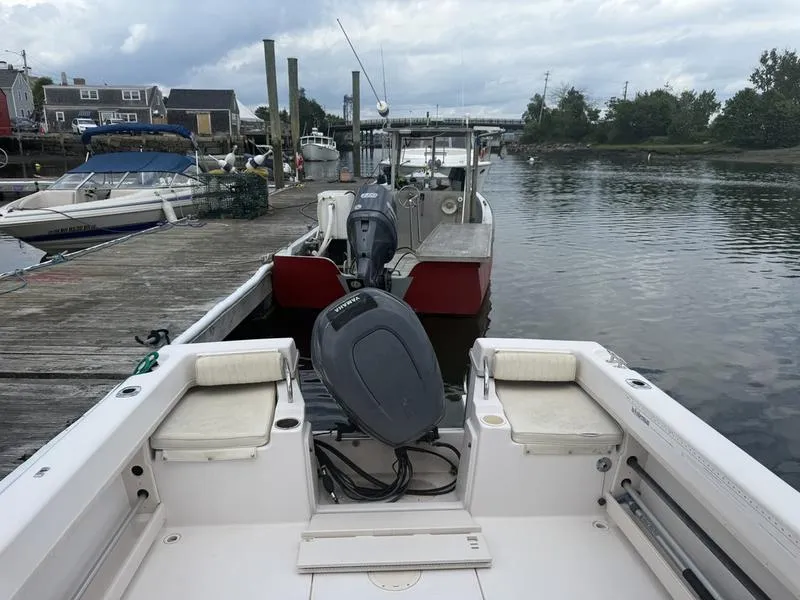 Slide: The Image of 2003 Grady-White 226 Sea Farer boat docked at a marina with overcast skies. - 7