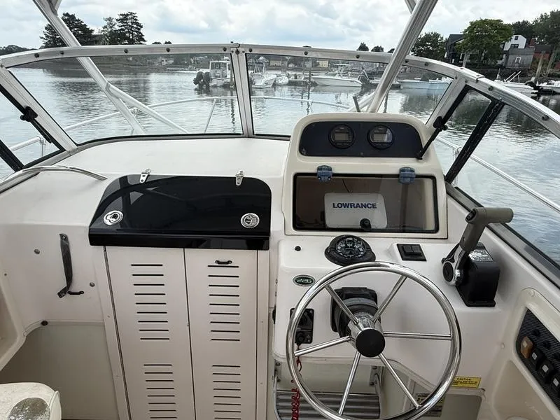 Slide: The Image of 2003 Grady-White 226 Sea Farer boat helm with steering wheel and navigation equipment. - 9