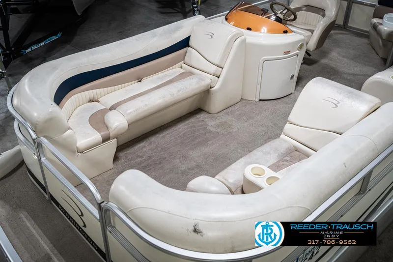 Slide: The Image of 2007 Bennington 2050 GL pontoon boat interior with beige seating and steering console. - 12