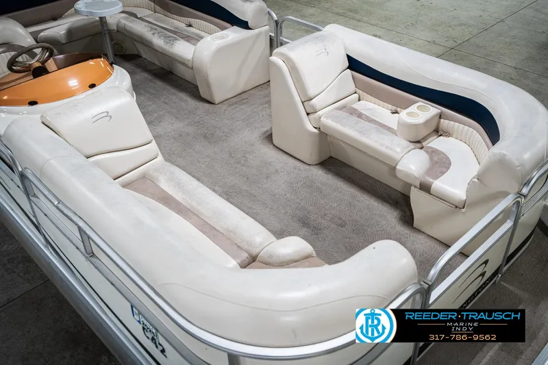 Slide: The Image of 2007 Bennington 2050 GL pontoon boat interior with beige seating and steering console. - 13