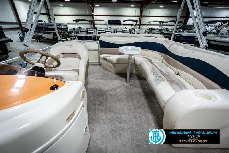 Slide: The Image of 2007 Bennington 2050 GL pontoon boat interior with seating and steering wheel in showroom. - 17