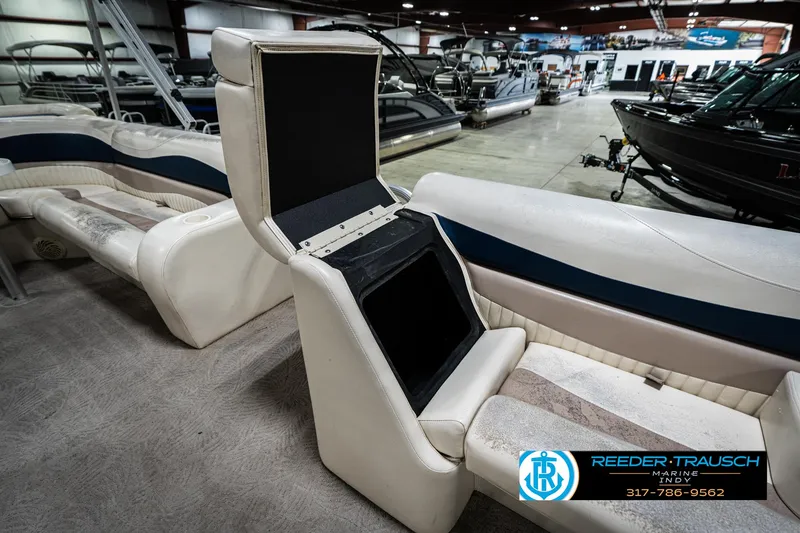 Slide: The Image of 2007 Bennington 2050 GL boat interior with open storage compartment in showroom. - 25