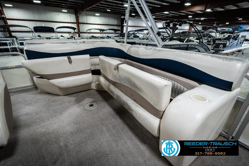 Slide: The Image of 2007 Bennington 2050 GL pontoon boat interior with white and blue seating in showroom. - 28