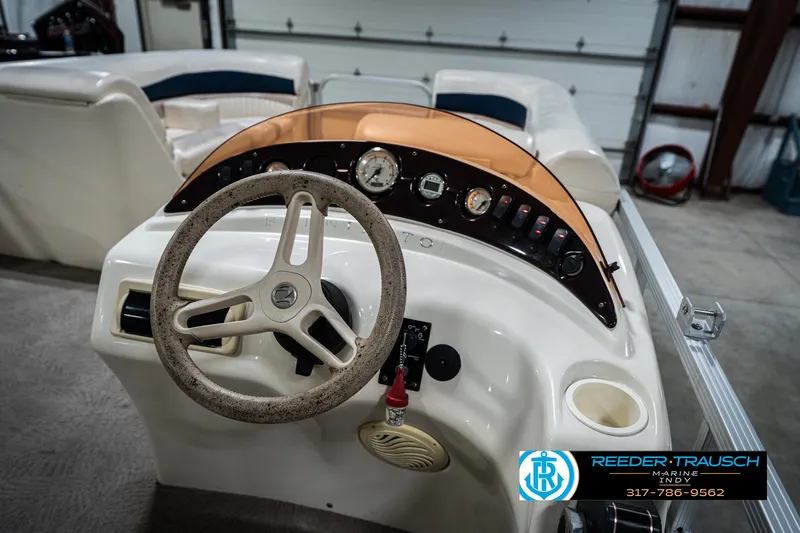 Slide: The Image of Steering console of a 2007 Bennington 2050 GL boat in a garage setting. - 31