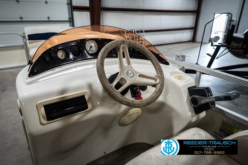 Slide: The Image of 2007 Bennington 2050 GL boat dashboard with steering wheel and controls in a garage setting. - 32