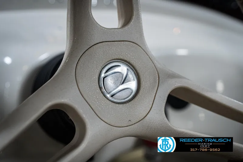 Slide: The Image of Steering wheel of a 2007 Bennington 2050 GL boat, featuring a central logo. - 33