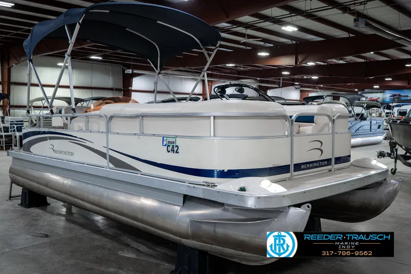 Slide: The Image of 2007 Bennington 2050 GL pontoon boat displayed indoors at Reeder-Trausch Marine showroom. - 6