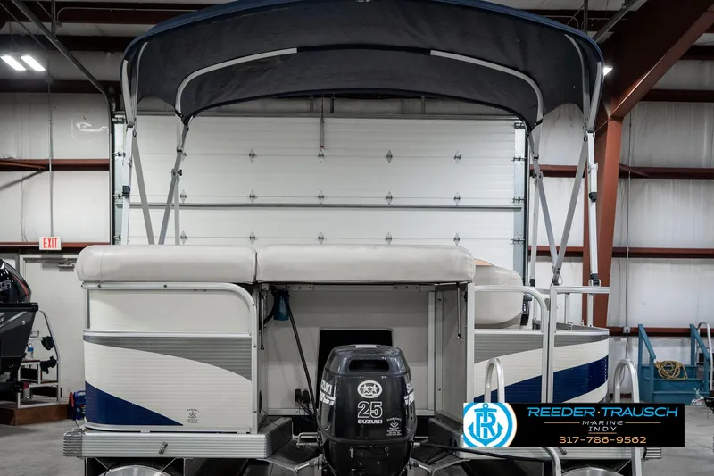 Slide: The Image of 2007 Bennington 2050 GL pontoon boat with Suzuki 25 HP engine in indoor storage. - 9
