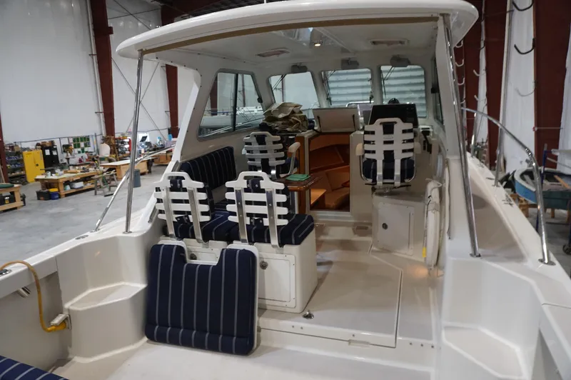 Slide: The Image of 2006 Back Cove 29 boat interior with striped seating in a workshop setting. - 10