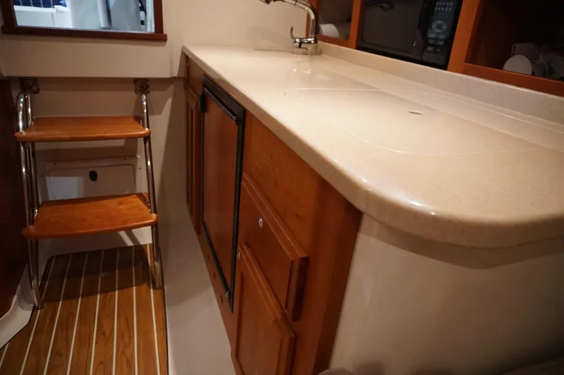 Slide: The Image of 2006 Back Cove 29 interior with wooden steps, countertop, and cabinetry. - 17
