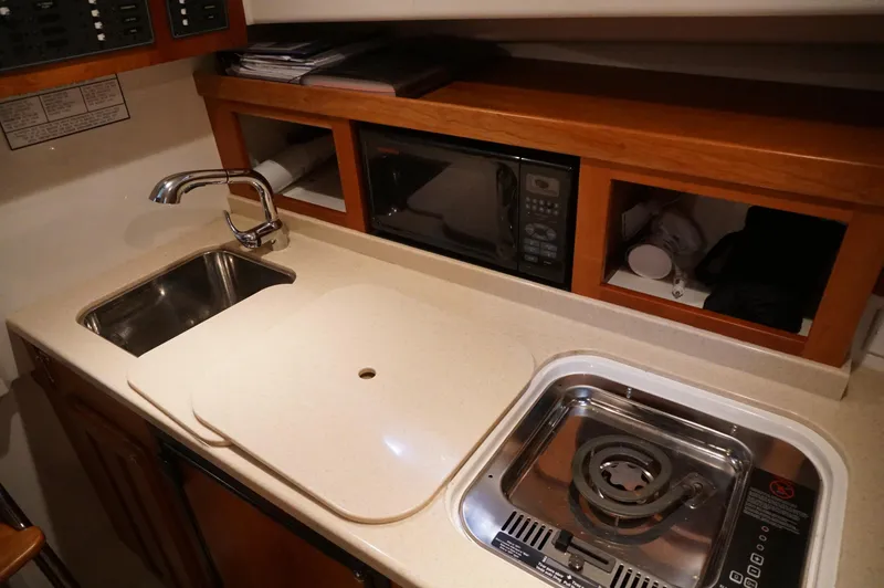 Slide: The Image of 2006 Back Cove 29 yacht galley with sink, stove, and microwave. - 20