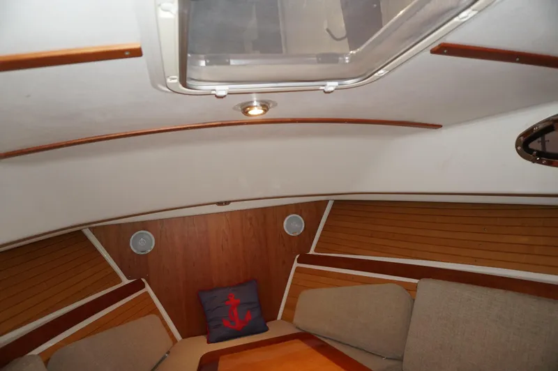 Slide: The Image of Interior of 2006 Back Cove 29 boat with cozy seating and nautical decor. - 21