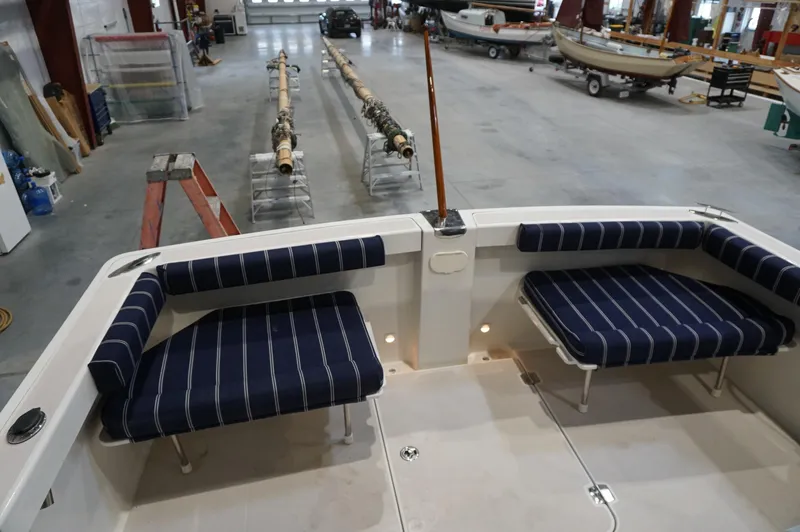 Slide: The Image of 2006 Back Cove 29 boat interior with striped seating in a spacious workshop. - 27
