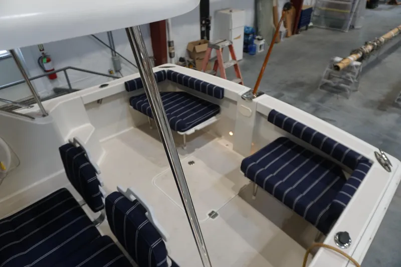 Slide: The Image of 2006 Back Cove 29 boat interior with striped seating in a workshop setting. - 37