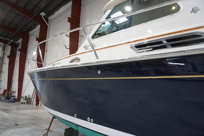 Slide: The Image of 2006 Back Cove 29 boat in a warehouse, showcasing sleek design and craftsmanship. - 38