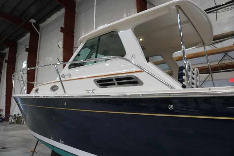 Slide: The Image of 2006 Back Cove 29 boat in a warehouse, showcasing sleek design and sturdy build. - 39