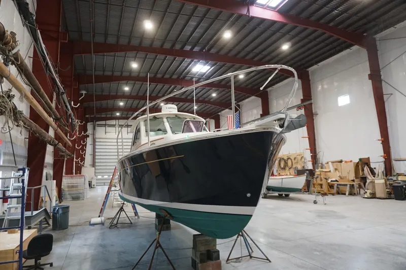 Slide: The Image of 2006 Back Cove 29 boat in a spacious indoor workshop setting. - 40