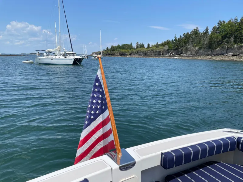 Slide: The Image of American flag on a 2006 Back Cove 29 boat, scenic coastal view. - 5