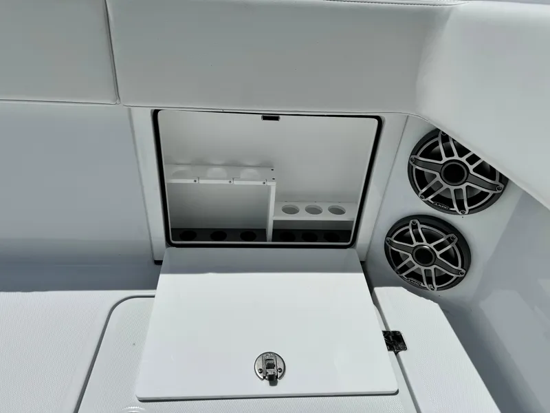 Slide: The Image of 2026 Invincible 38 Catamaran interior with storage compartment and dual speakers. - 10