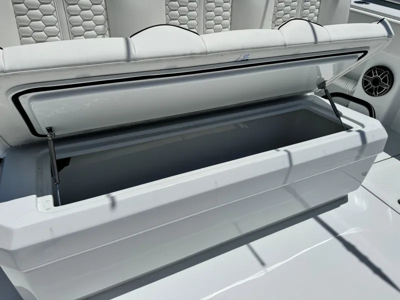Slide: The Image of Open storage compartment on 2026 Invincible 38 Catamaran with cushioned seating. - 13