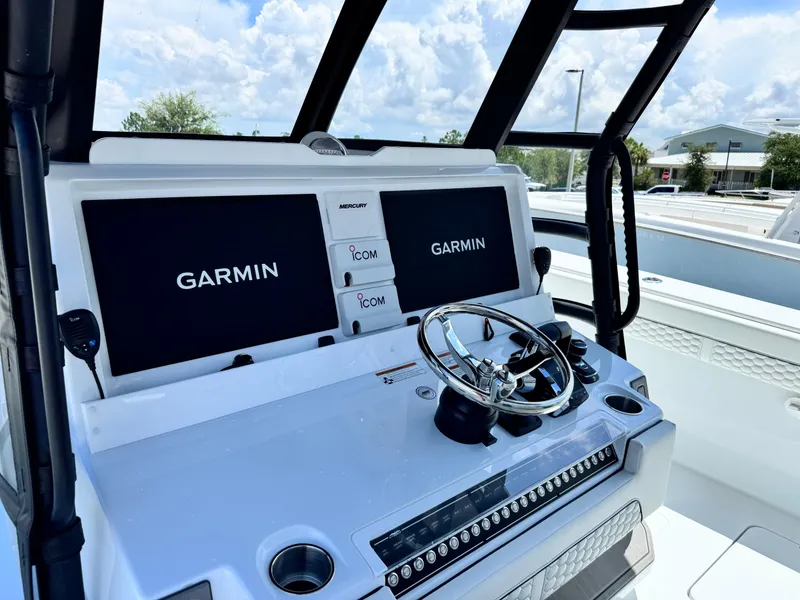 Slide: The Image of 2026 Invincible 38 Catamaran helm with Garmin displays and steering wheel. - 18