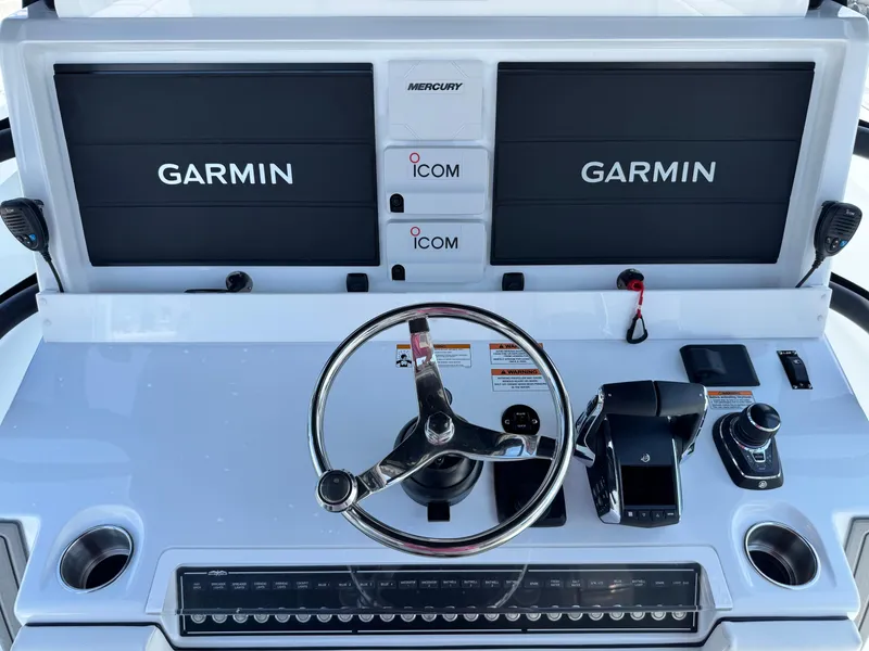 Slide: The Image of 2026 Invincible 38 Catamaran helm with Garmin displays and Mercury controls. - 20