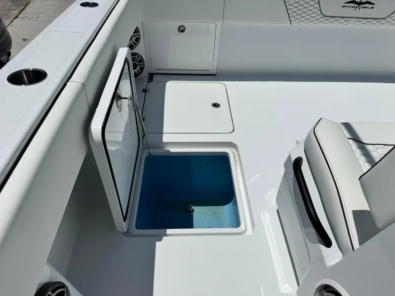 Slide: The Image of 2026 Invincible 38 Catamaran interior with open storage compartment and seating. - 22