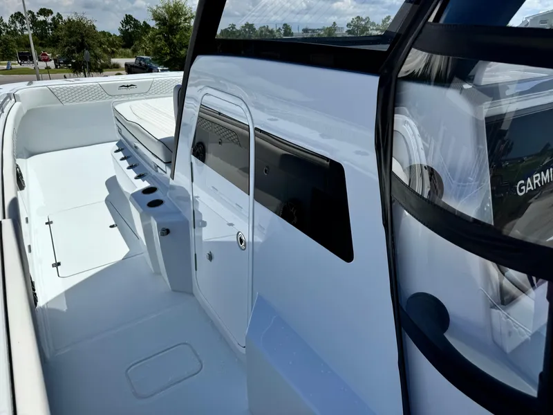 Slide: The Image of 2026 Invincible 38 Catamaran interior with seating and Garmin equipment. - 23