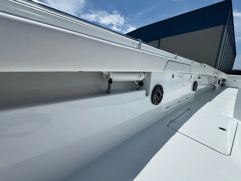 Slide: The Image of 2026 Invincible 38 Catamaran deck view with speakers and storage compartments. - 29