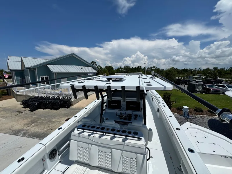 Slide: The Image of 2026 Invincible 38 Catamaran docked, showcasing sleek design and advanced navigation equipment. - 34